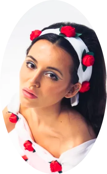 A model in a white headband dotted with red roses