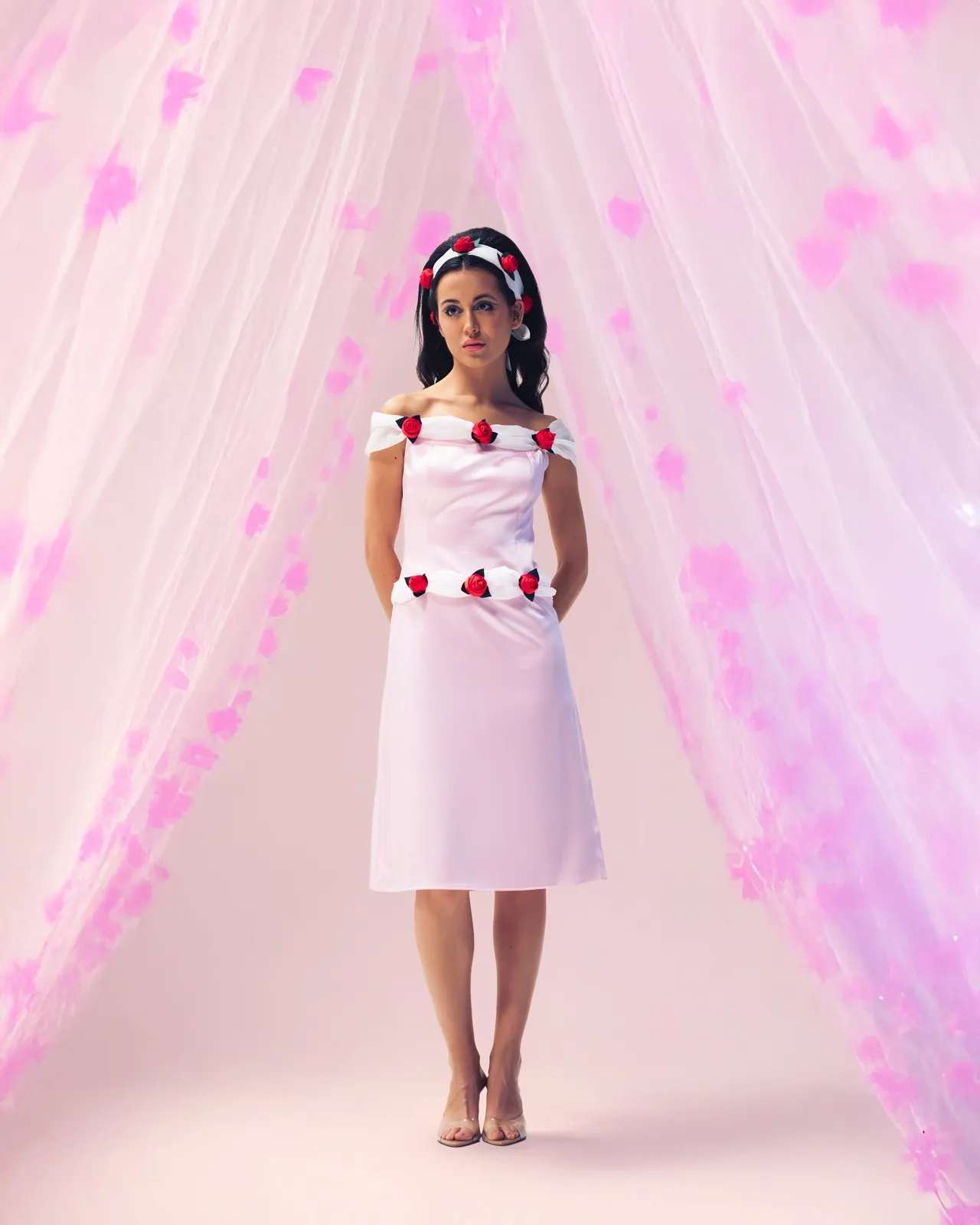 The rose-trimmed dress from the premiere collection, under a pink tulle canopy